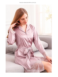 Macro detail of dusky pink ice silk robe with delicate lace trim on cuffs and hem