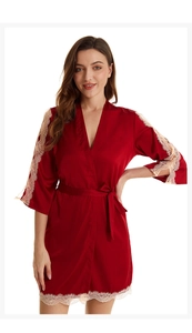 Close-up of red silk satin robe with elegant gold lace trim and matching waist tie belt