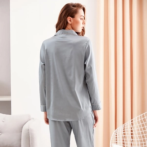Elegant grey-blue satin pajama set for women featuring long sleeves and a silky drape finish