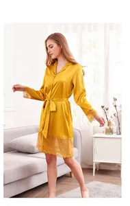 Close-up of ginger satin robe with intricate lace trim on sleeves and hemline details