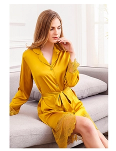 Close-up of ginger yellow ice silk robe featuring intricate lace trim on sleeves and hem