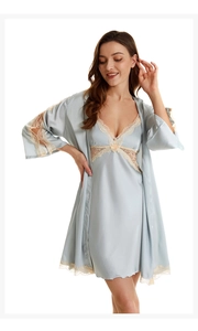 Detailed view of blue satin nightgown with elegant beige lace trim on hem and cuffs
