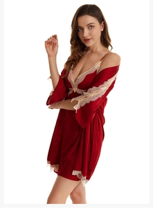 Detail of silk-like dark red bathrobe set with delicate lace trim on sleeves and hem