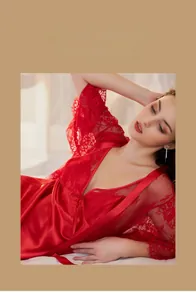 Detail of red silk nightdress set with delicate lace trim and long sleeve floral robe