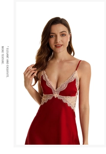 Close-up of deep V-neckline with beige lace trim on a red silk satin nightgown