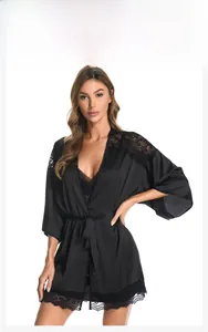 Detailed view of black satin sleepwear robe with delicate floral lace trim and waist tie
