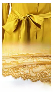 Detail of ginger silk robe featuring a bow waistband and eyelash floral lace hemline