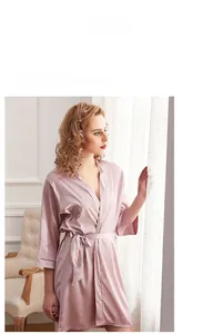 Elegant bean paste pink silk robe with sash tie in a cozy home setting macro shot