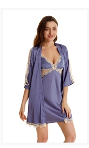 Detail view of purple satin pajama set featuring delicate beige lace trim on the robe cuffs