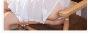Close-up of white sheer mesh nightgown featuring delicate lace hem and tiered design