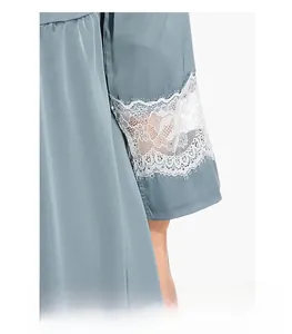 Détail de la robe en soie bleu clair avec dentelle blanche délicate et tissu satiné lisse