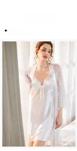 Detail of white lace robe and silk slip dress featuring delicate bow and lace trim