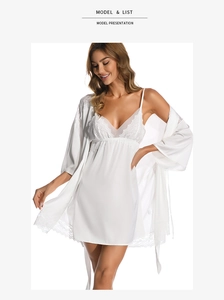 Detailed view of white silk pajamas with V-neck lace trim and matching satin robe