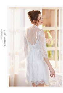 Detailed view of white lace bathrobe with elegant eyelash trim and sheer back lace panels