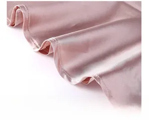 Macro detail of the light pink ice silk satin fabric showing premium hem stitching