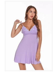 Detail view of purple modal nightgown with delicate white floral lace embroidery and thin straps