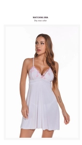 Detail of pink floral lace embroidery on white modal slip nightgown with deep V-neck