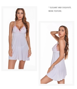 Detail of white modal slip nightgown featuring pink floral lace embroidery and deep V-neck