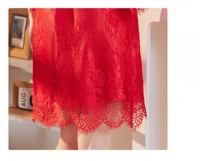 Detailed close-up of red eyelash lace hem on a silk nightgown with floral texture
