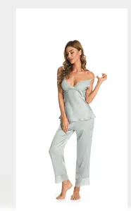 Detail of silk satin camisole set featuring delicate lace trim on neckline and hemline