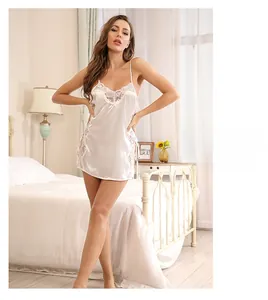 Detail of white satin lace nightgown showing fine floral lace trim and glossy fabric