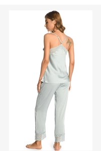 Detail of light blue silk pajamas set with delicate lace trim on camisole and pants