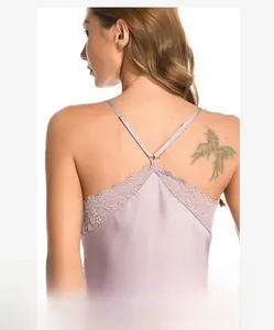 Close-up of the elegant lace trim and cross-back straps on this silky lavender sleepwear