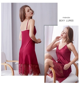 Dettaglio di camicia da notte in raso rosso con bordo in pizzo e scollo a V su modella