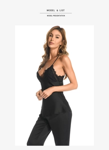 Close-up of black satin sleepwear set featuring delicate lace trim and silk texture