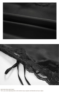 Detail of adjustable metal buckles and delicate lace trim on black satin nightgown