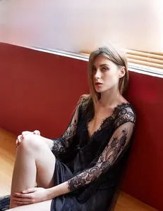Detailed close-up of delicate floral eyelash lace sleeves and black silk camisole set