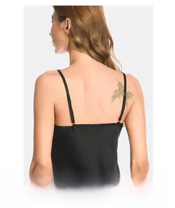 Close-up of adjustable thin straps and back detail on black satin silk sleepwear