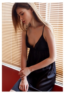 Close-up of black ice silk nightgown with delicate lace V-neckline and satin finish