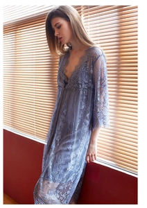Close-up of light blue floral lace robe with intricate sheer texture and scalloped edges
