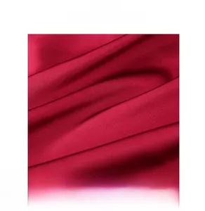 Detail of red faux silk pajamas featuring a high-quality elastic waistband and smooth fabric