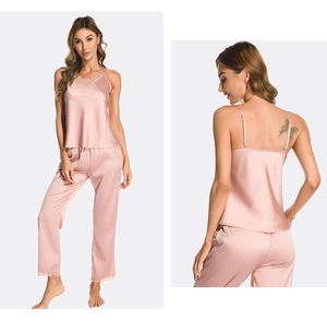Detail view of silk satin pajama set with V-neck lace trim and matching pants in rose gold