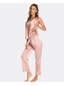 Close-up of silk pajama set featuring delicate lace trim on V-neck and satin texture