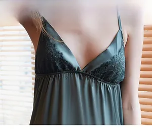 Detail of dark green satin nightgown featuring delicate floral lace and deep V-neckline