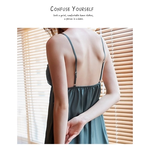 Detail of dark green satin nightgown showing thin straps and elegant open back design