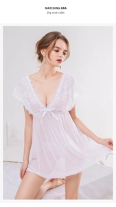 Close-up of white lace nightgown with V-neckline floral lace and satin bow detail