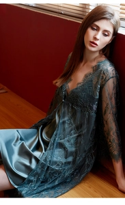 Detail of dark green lace robe and silk camisole set with intricate floral patterns