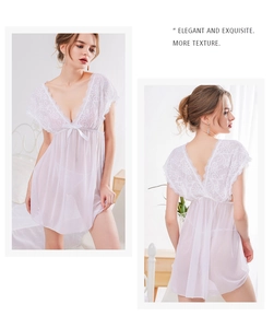 Detail of white lace nightgown with V-neckline, floral embroidery and sheer mesh fabric