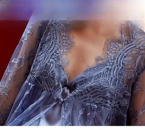 Detail view of dusty blue lace robe featuring delicate floral embroidery and eyelash lace trim