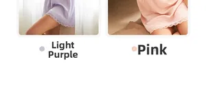 Close-up of silk sleepwear shorts with delicate lace trim in light purple and pink