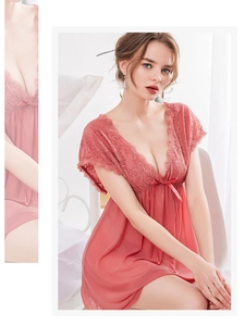 Detailed close-up of pink lace V-neckline and bow on sheer mesh nightgown