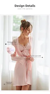 Detailed close-up of pink silk satin robe set featuring floral lace trim and removable pads
