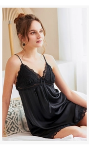 Detail view of black silk satin slip dress with exquisite lace trim and bow drawstring