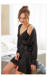 Detailed view of black satin sleepwear set with delicate eyelash lace trim and silk texture