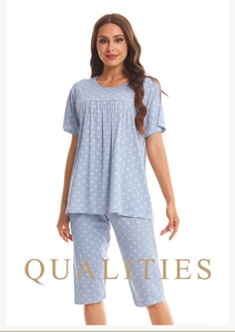 Detail of light blue short sleeve pajama set with pink polka dots and pleated neckline