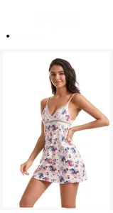 Detailed view of the V-neck lace trim and floral print on a white satin nightgown